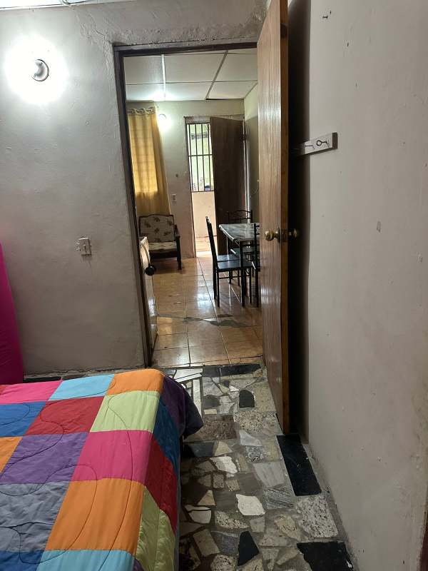 Bedroom space double bed colorful quilt curtains Villa Lobos Pedregal Panama