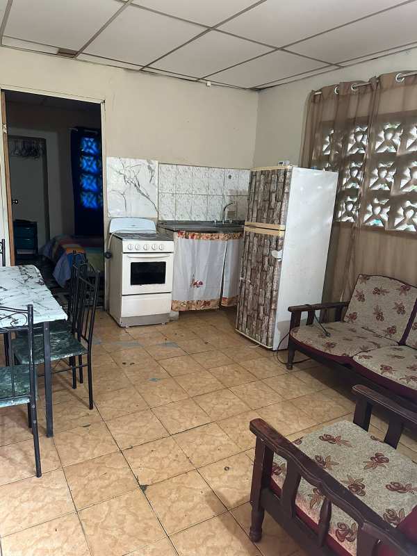 Basic kitchen with refrigerator, stove and dining table Villa Lobos Pedregal Panama
