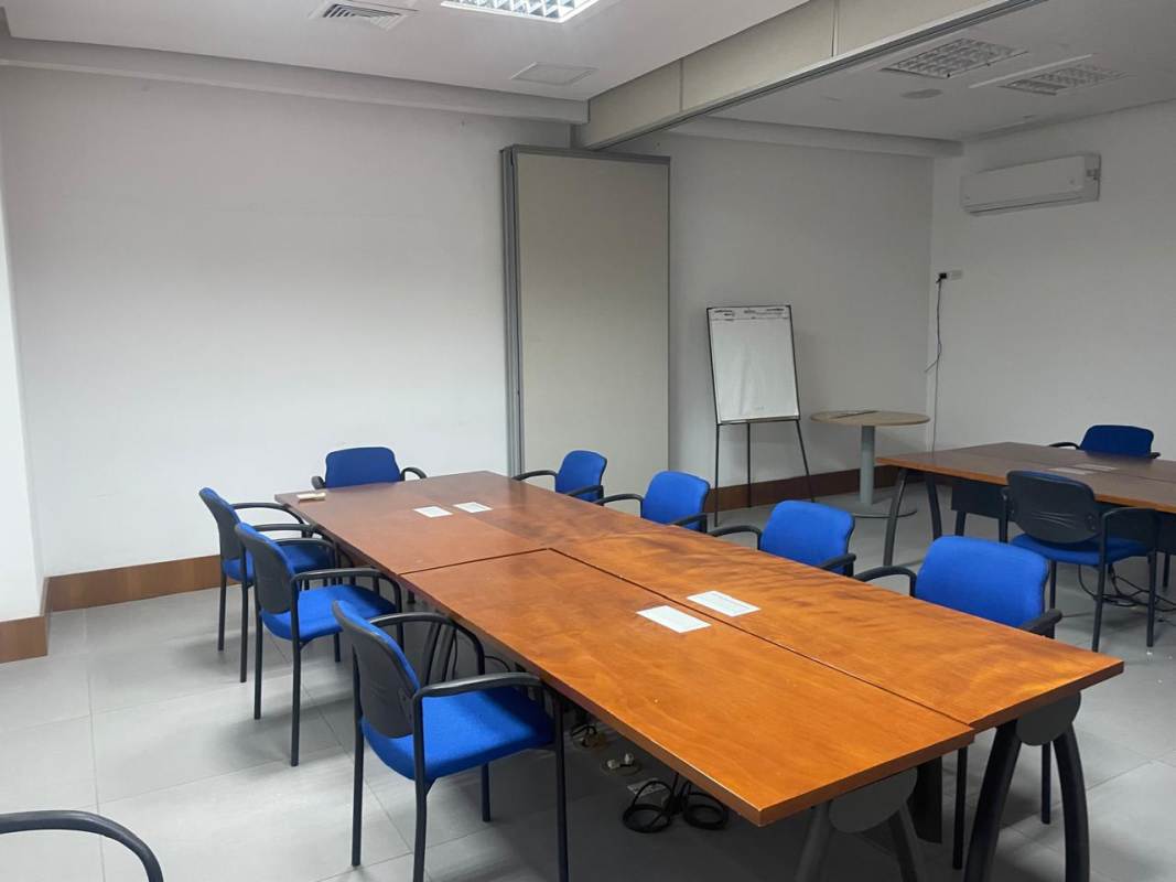 Modern conference room in Call Center office with wood table and blue chairs at Calle 50 Panama