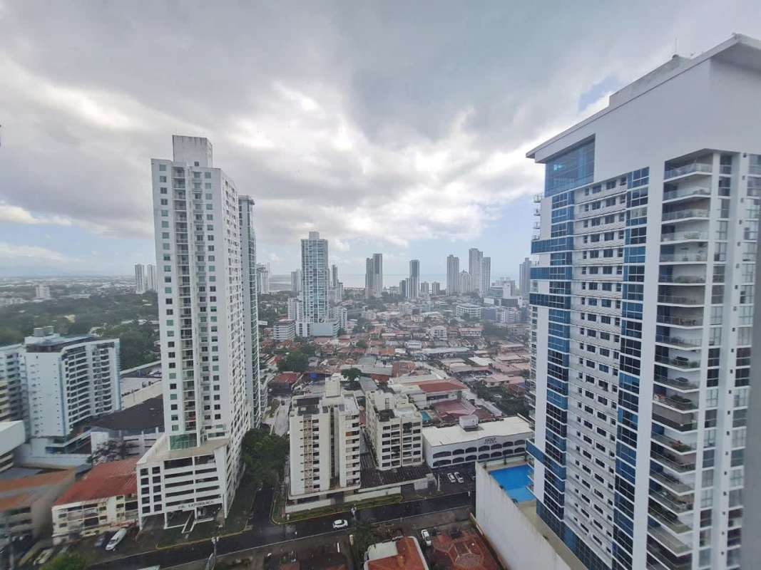 Bright open living room with city-view balcony in PH Quadrat Panama City