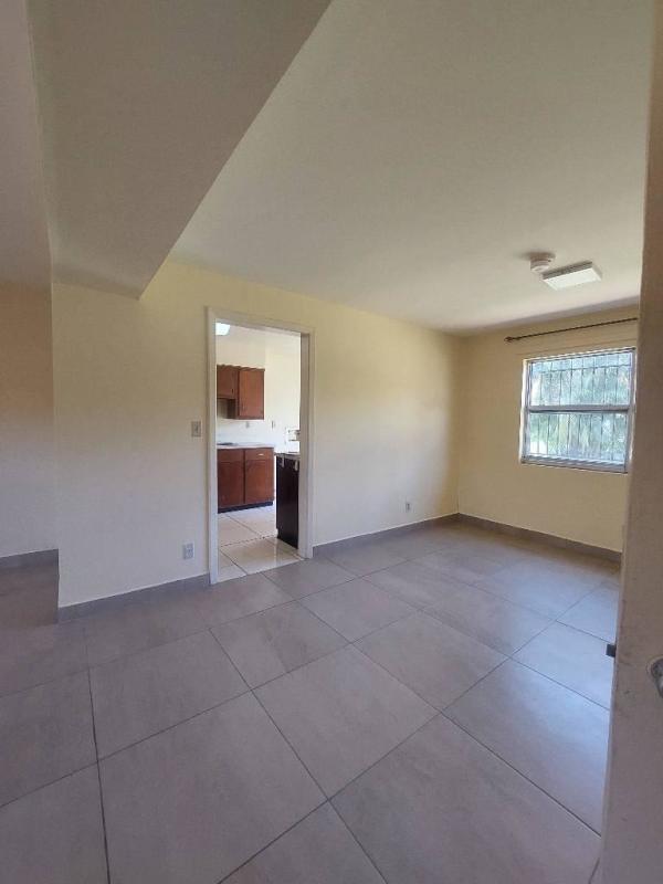 Open plan living dining room with tile floors and sunlight in Clayton apartment for rent Panama