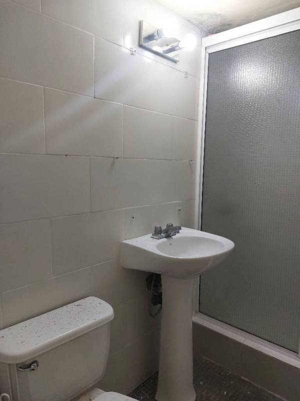 Well-lit living room with tiled floors and multiple windows at Clayton apartment Panama