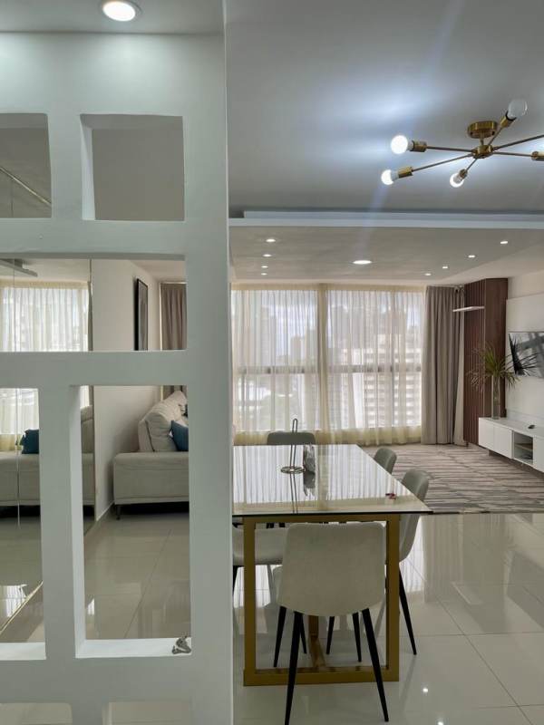 Large furnished bedroom with AC, window view of city skyline Obarrio Panama