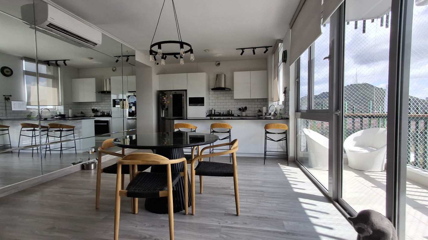 Open living dining space with panoramic window view in modern apartment Altos de Panama