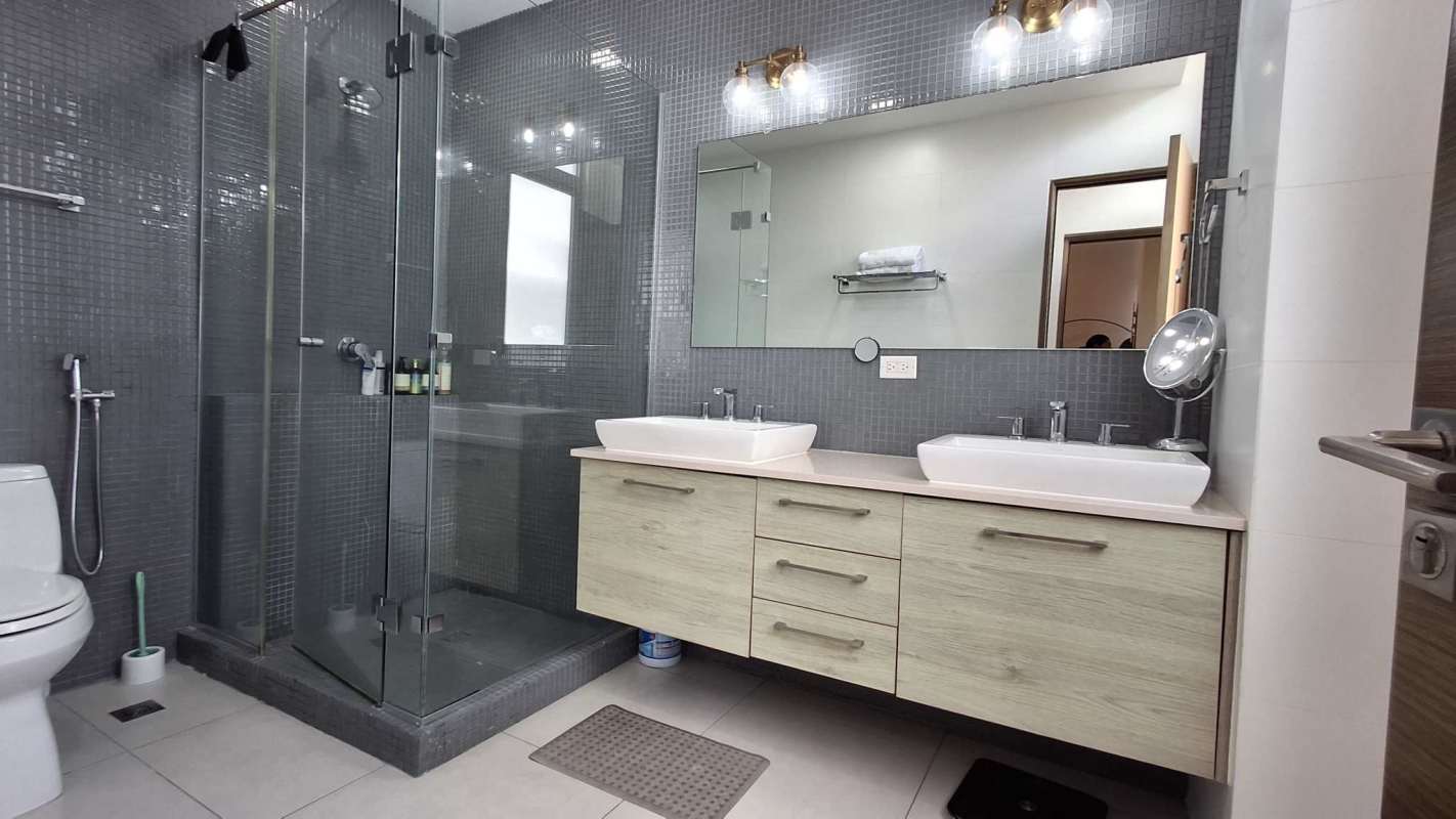 Modern bathroom featuring double vanity, glass shower and mosaic tile Condado del Rey Panama