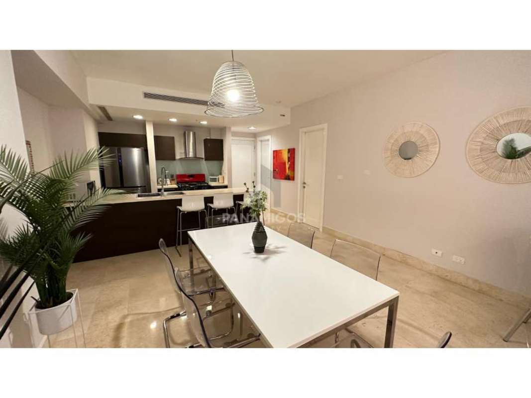 Bright open-plan living room with floor-to-ceiling windows and access to balcony in Yoo Panama on Avenida Balboa