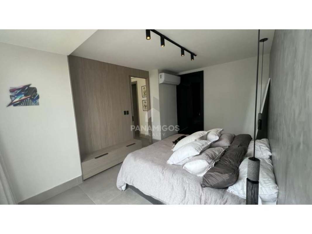 Stylish bedroom with accent wall and floor-to-ceiling windows in Victory Wellness Coco del Mar Panama