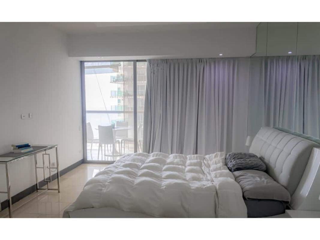 Spacious master bedroom with floor-to-ceiling window, ocean view at The Ocean Club Punta Pacífica Panama City