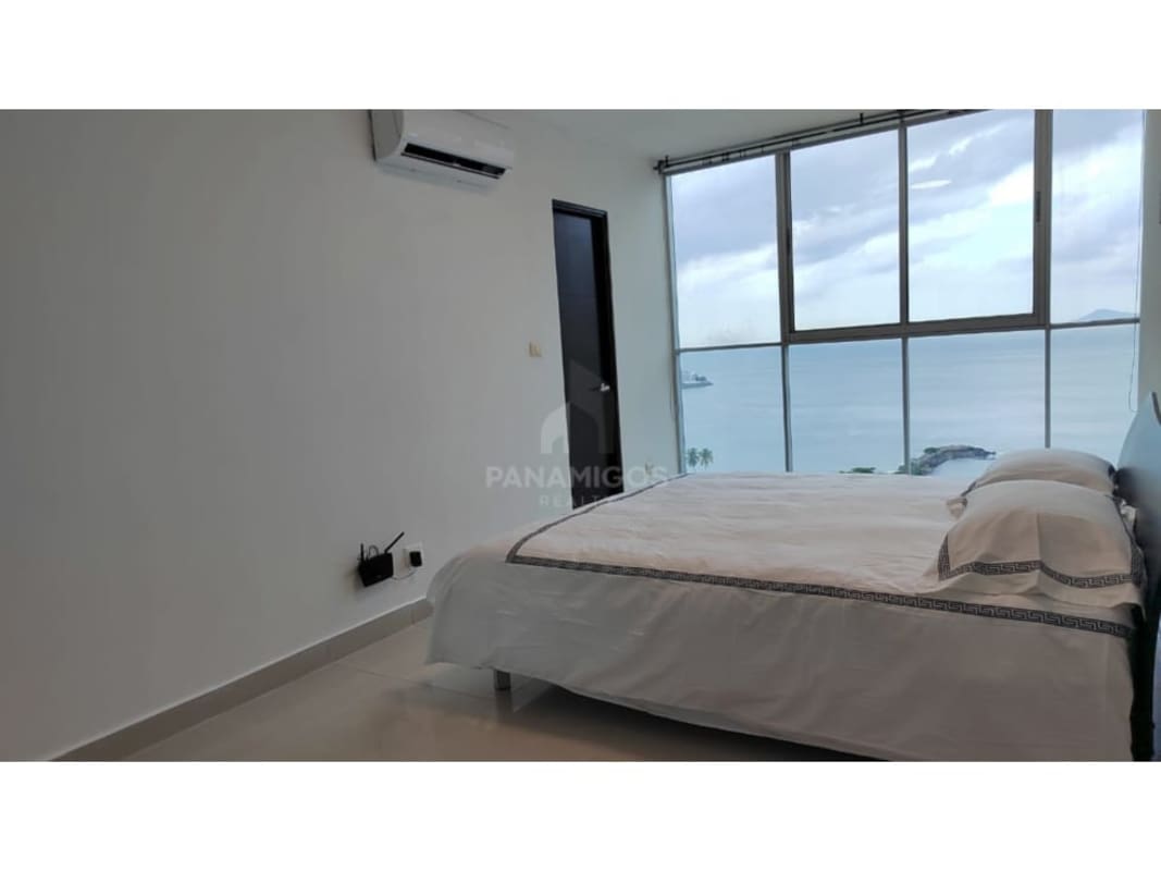 Master bedroom with large window, ocean view and built-in closet Punta Pacifica Panama