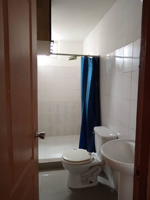 Empty bedroom with large window tiled floor white walls in Juan Díaz apartment Panama City