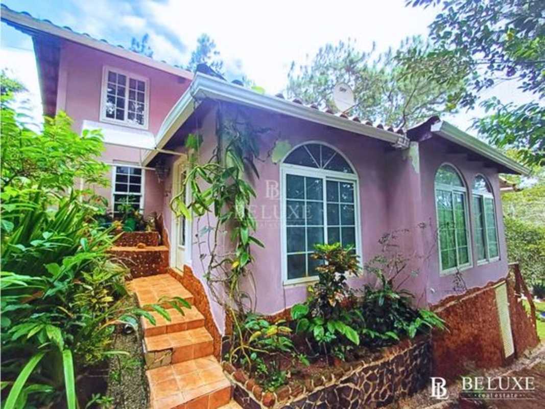 Two-story rustic mountain home with balconies, garden, and terrace for sale in Cerro Azul