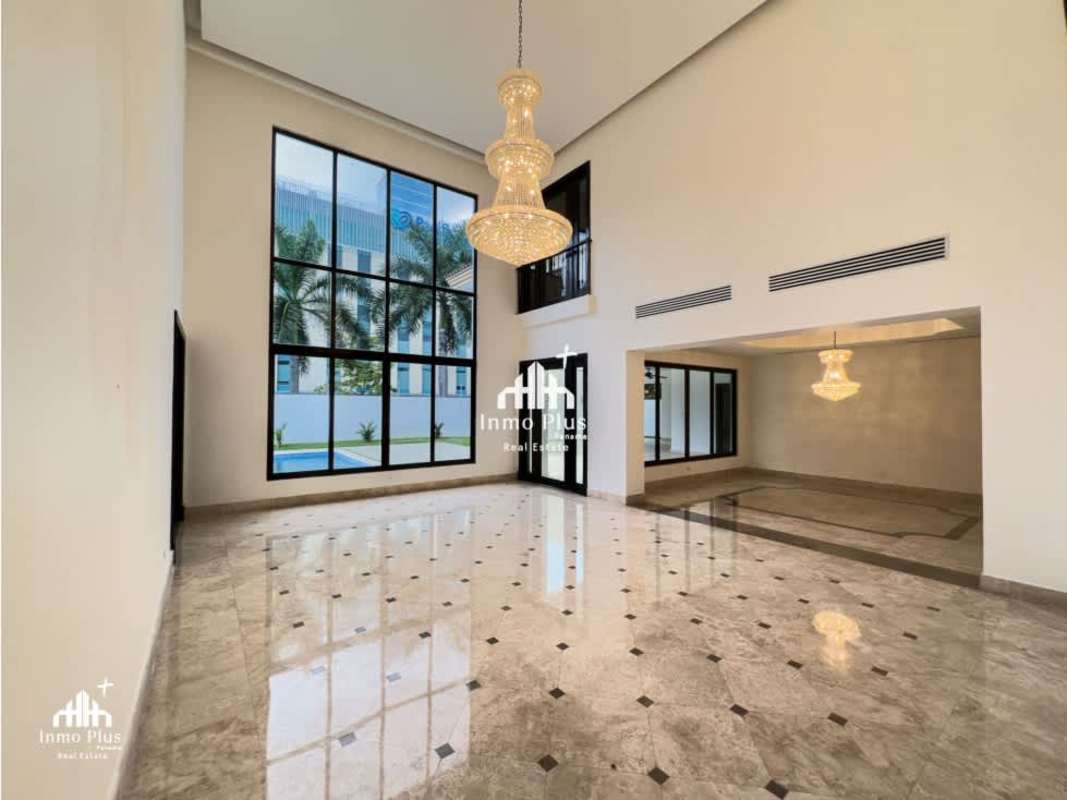 Entry foyer with marble floors, curved staircase, chandelier, luxury home Costa del Este Panama