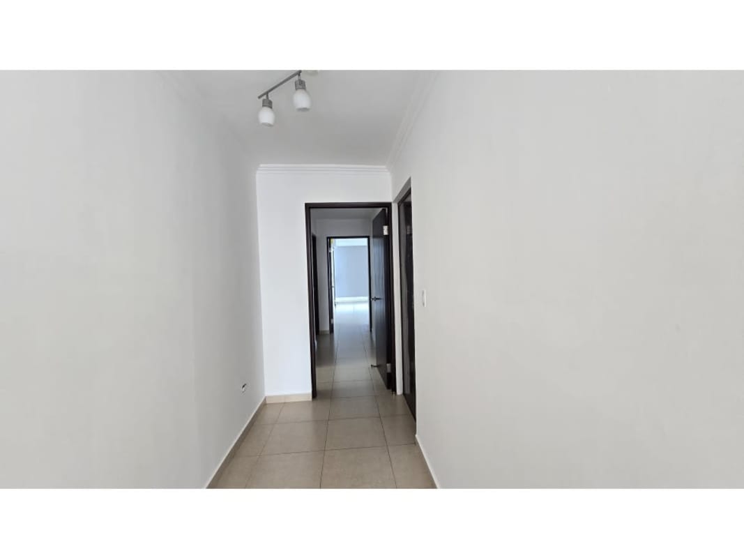 White corridor with tile floor and modern lighting in PH Sol del Este Costa del Este Panama