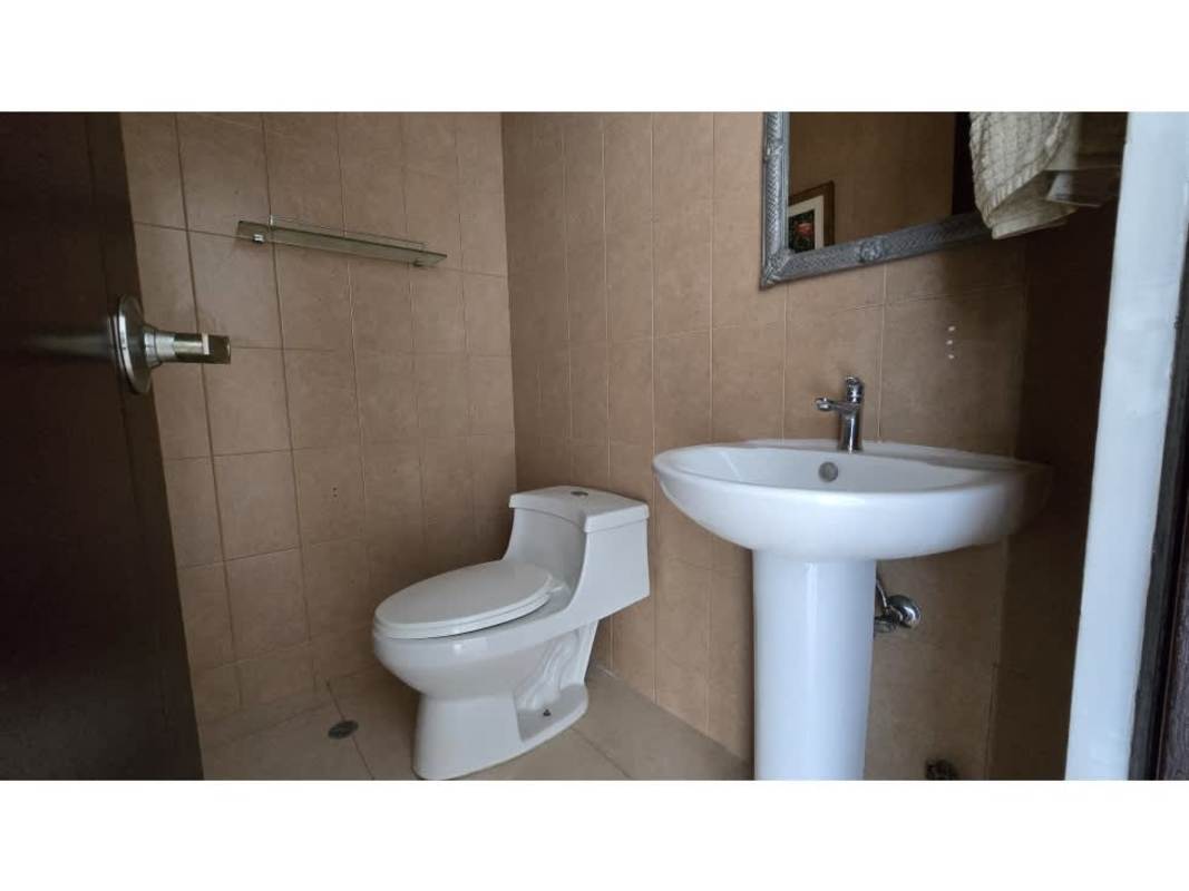 Modern bathroom with granite vanity, large mirror, and glass shower enclosure in PH Sol del Este