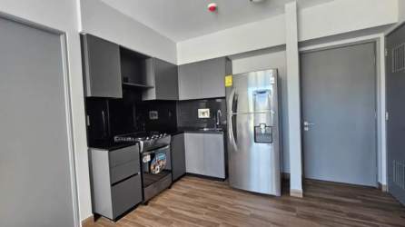 Bright unfurnished living room with sliding doors to balcony with pool view in PH Mosaic Panama Pacifico