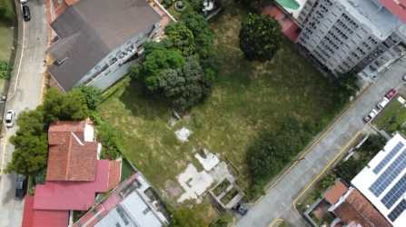 Aerial city view showing vacant land plot in central Panama City for sale