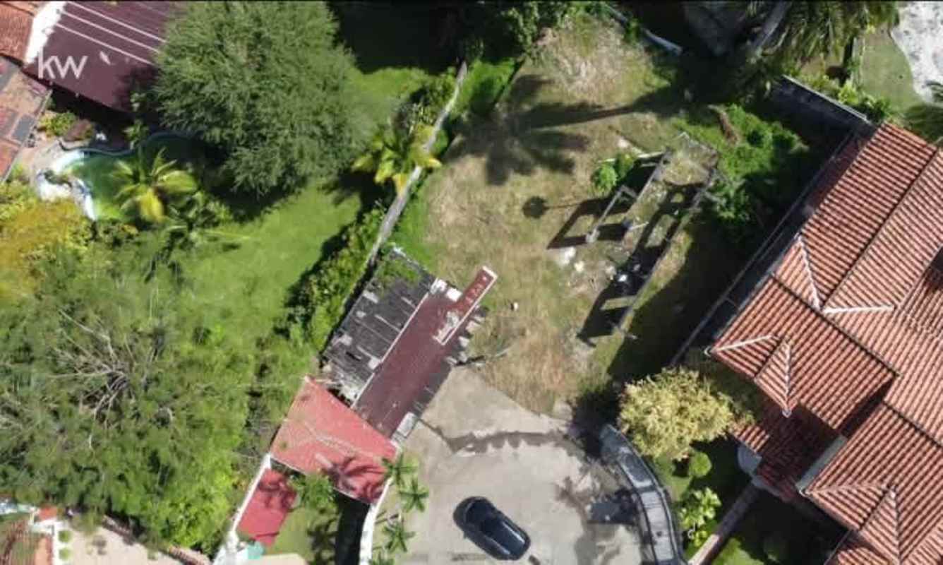 Large garden area with swimming pool and red-tiled roofs San Francisco Panama aerial