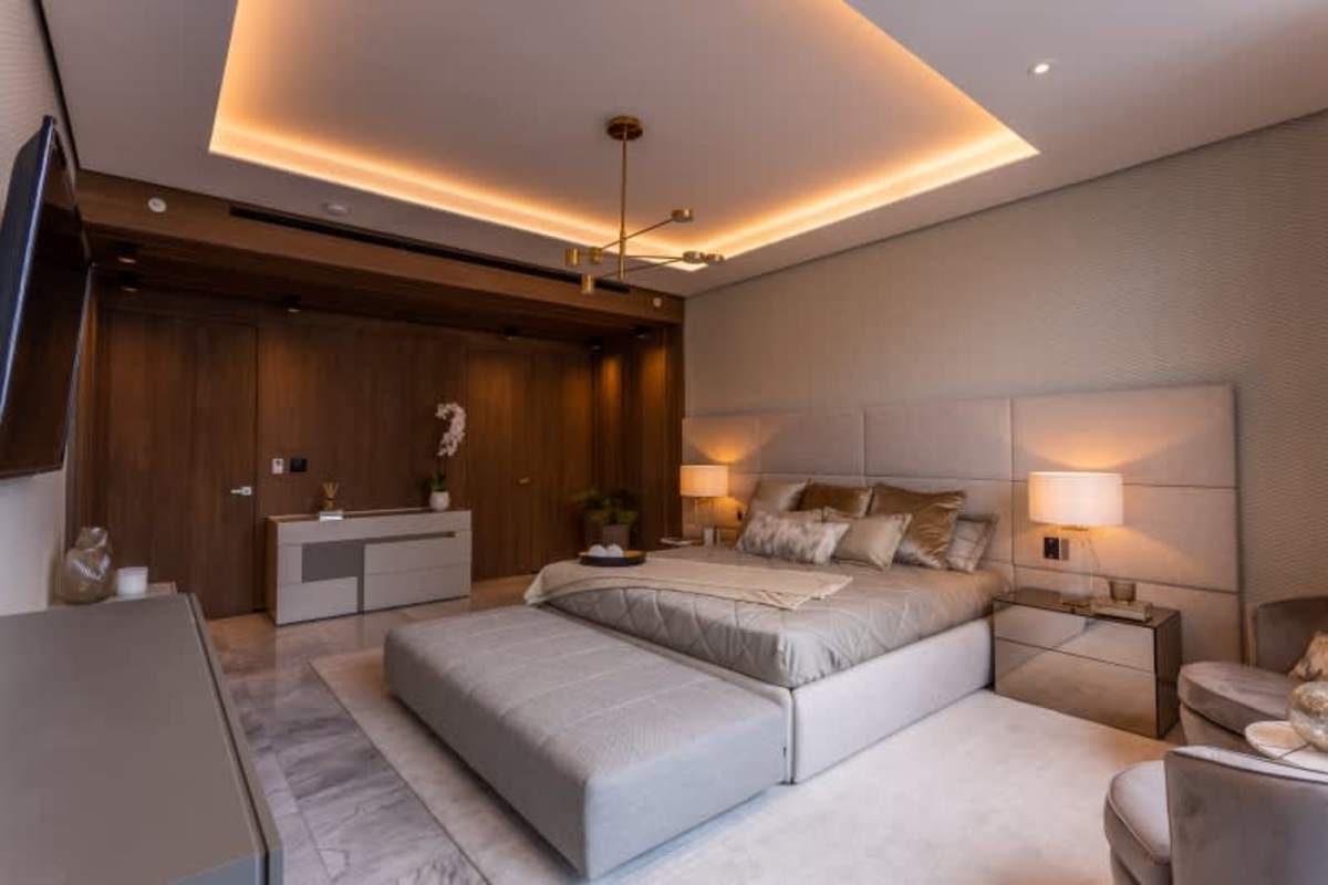 Elegant master suite featuring upholstered bed, luxury finishes, large windows with water views in PH Punta Paitilla