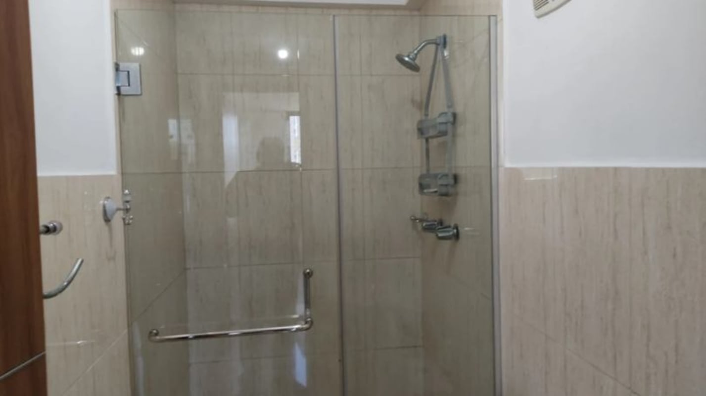 Modern bathroom with glass shower enclosure and ceramic fixtures in PH Mahogany Tower Panama