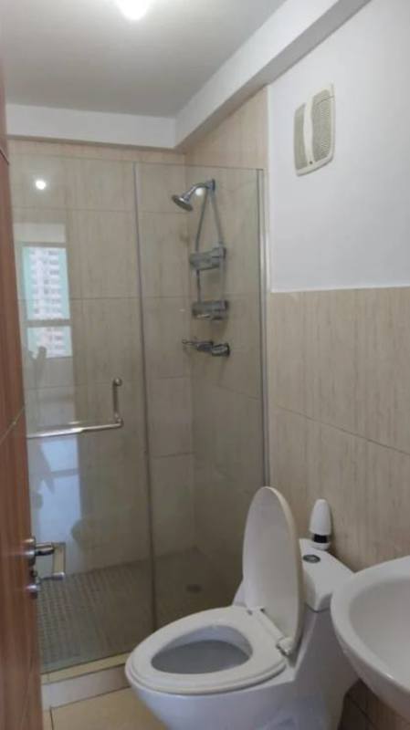 Minimalist bathroom with glass enclosed shower at PH Mahogany Tower Condado del Rey Panama