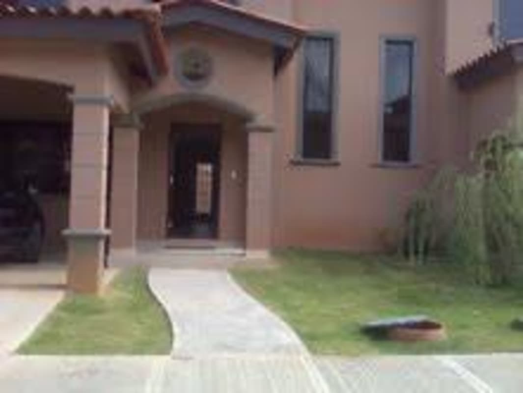 Mediterranean-inspired facade of Versalles house with columns and arched doorway Costa Sur Panama