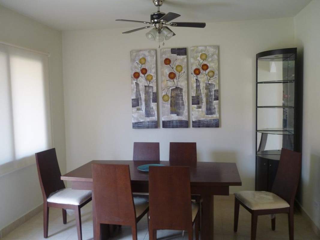 Bright dining area with wooden table, ceiling fan and modern decor in Versalles Costa Sur Panama