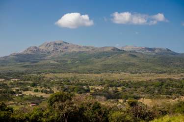 Open lot with hills and distant mountains under blue sky Coclé Panama