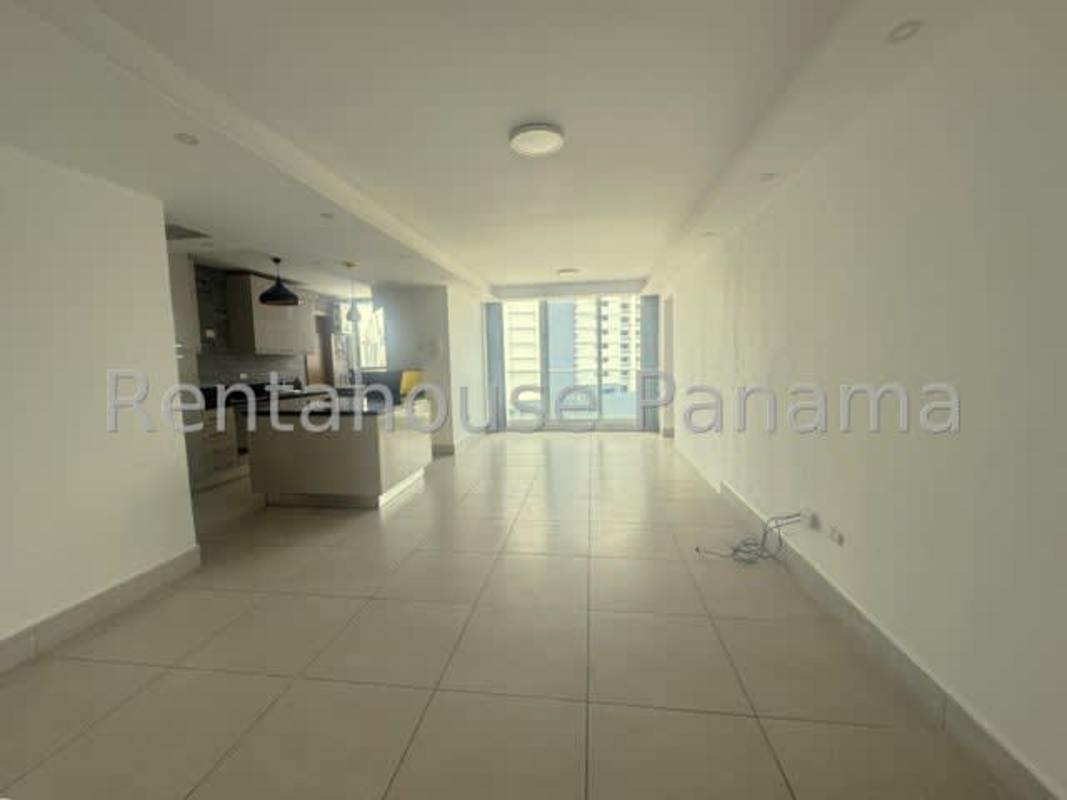 Spacious master bedroom with large windows overlooking Obarrio skyline in PH Park City Panama City