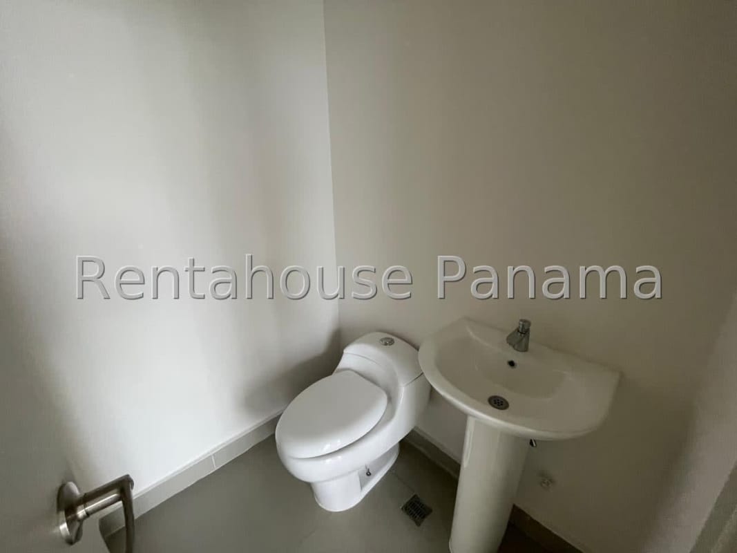 Compact minimalist bathroom with sink and toilet inside Ocean Business Plaza Panama
