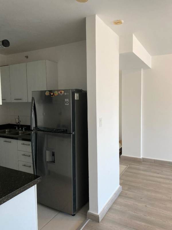 Open kitchen with granite countertop, white cabinets and modern appliances PH Tee One Panama