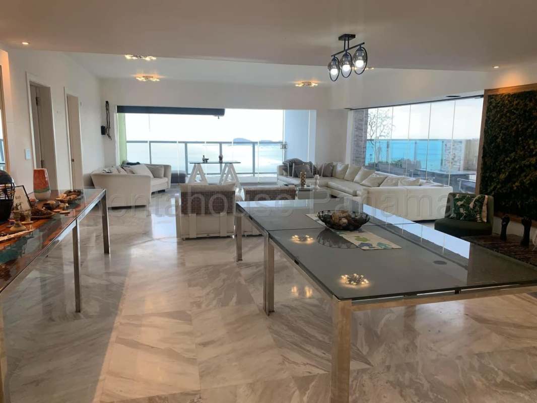 Spacious modern living area with marble floors and ocean views in Yoo Panama penthouse
