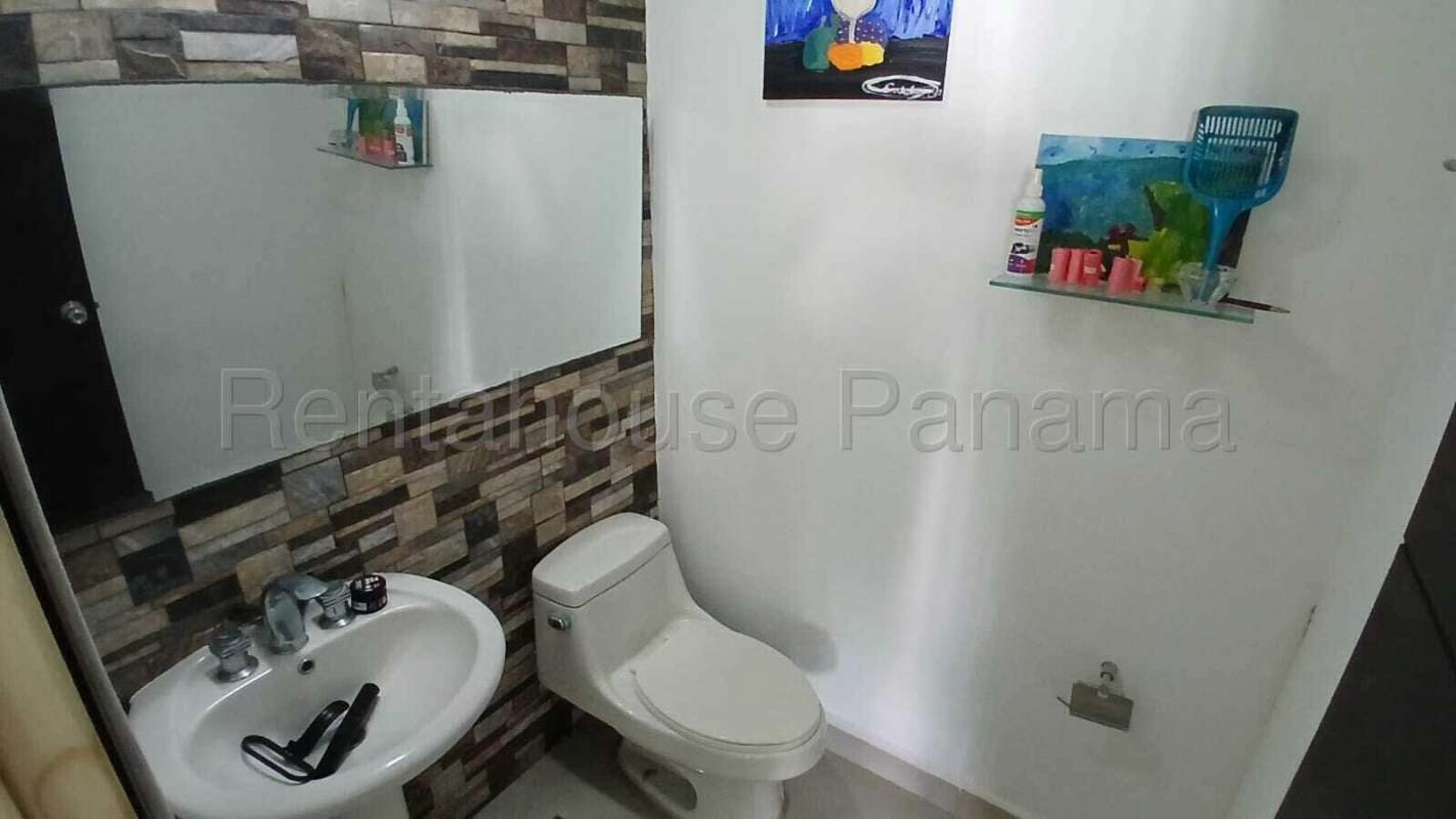 Modern kitchen with granite countertops, stainless appliances, white cabinetry in Panama San Francisco apartment for sale