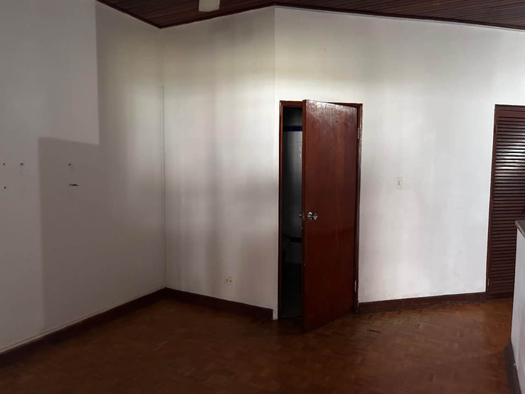 Wood staircase with decorative iron railings in duplex home Obarrio Bella Vista Panama City