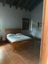 Covered veranda patio overlooking garden with arches on large farm estate in Sora Panama