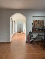 Interior hallway with arches, terracotta tiles and natural light in country estate Panama