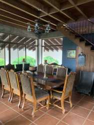 Bedroom featuring exposed wood beams, terracotta tile floor and rustic furnishing Sora Panama estate