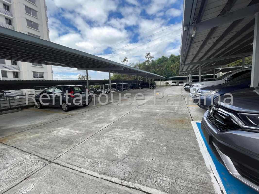 Covered parking area next to residential towers at PH Rokas Panama