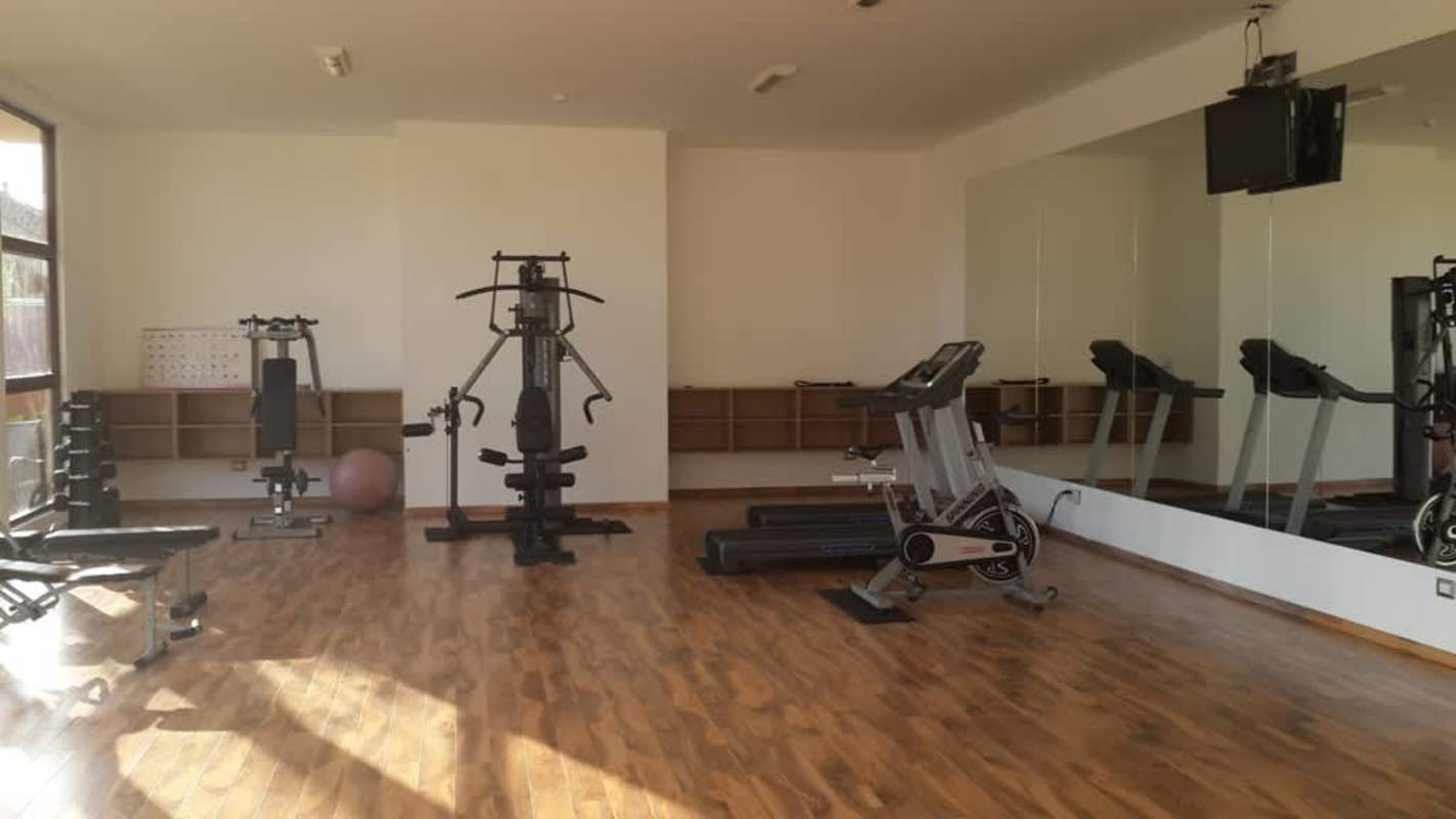 Resort-style pool, jacuzzi, swim-up bar, palm trees, tennis court at Sunset Coast Costa Sur Panama City