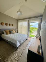 Bedroom with large sliding door to terrace, natural light, modern finishes in Playa Caracol