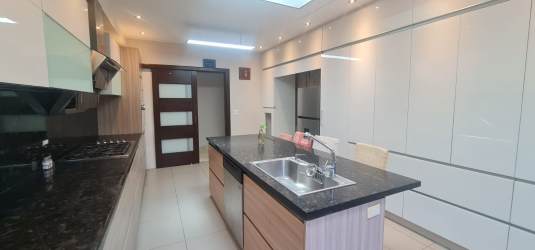 Bright contemporary kitchen with center island and sleek cabinetry Margarita Colón