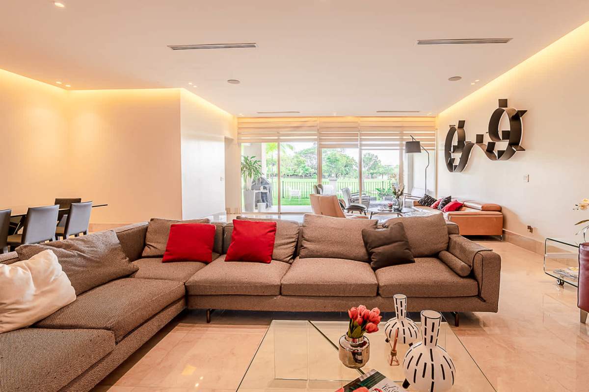 Elegant dining room open to living area with marble floors at The Reserve Santa María Panama