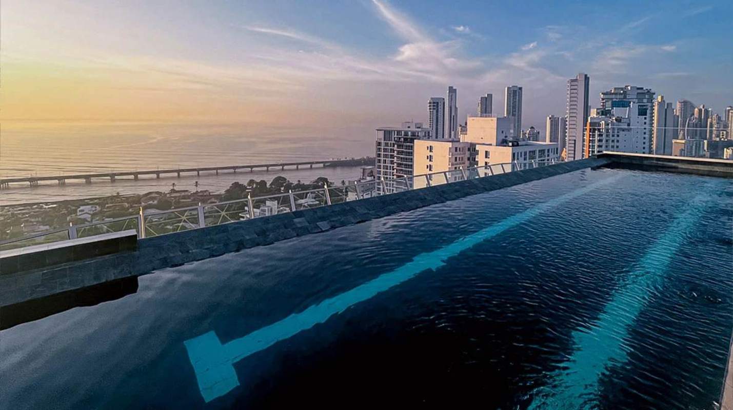 Furnished bedroom with balcony access and sea views in Victory Wellness Panama