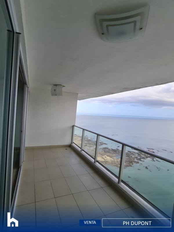 Private balcony with glass railing featuring stunning views of Pacific Ocean from high-rise apartment in Punta Pacifica