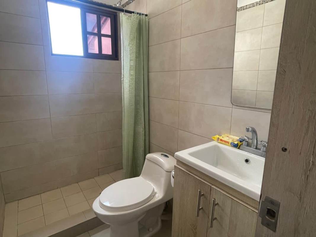 Modern kitchen with white cabinets, stainless steel appliances in La Reserva Villa Zaita house Panama