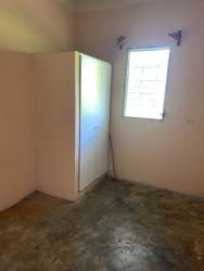 Bedroom with pink walls, concrete floor, built-in closet at rental apartment La Chorrera Panama