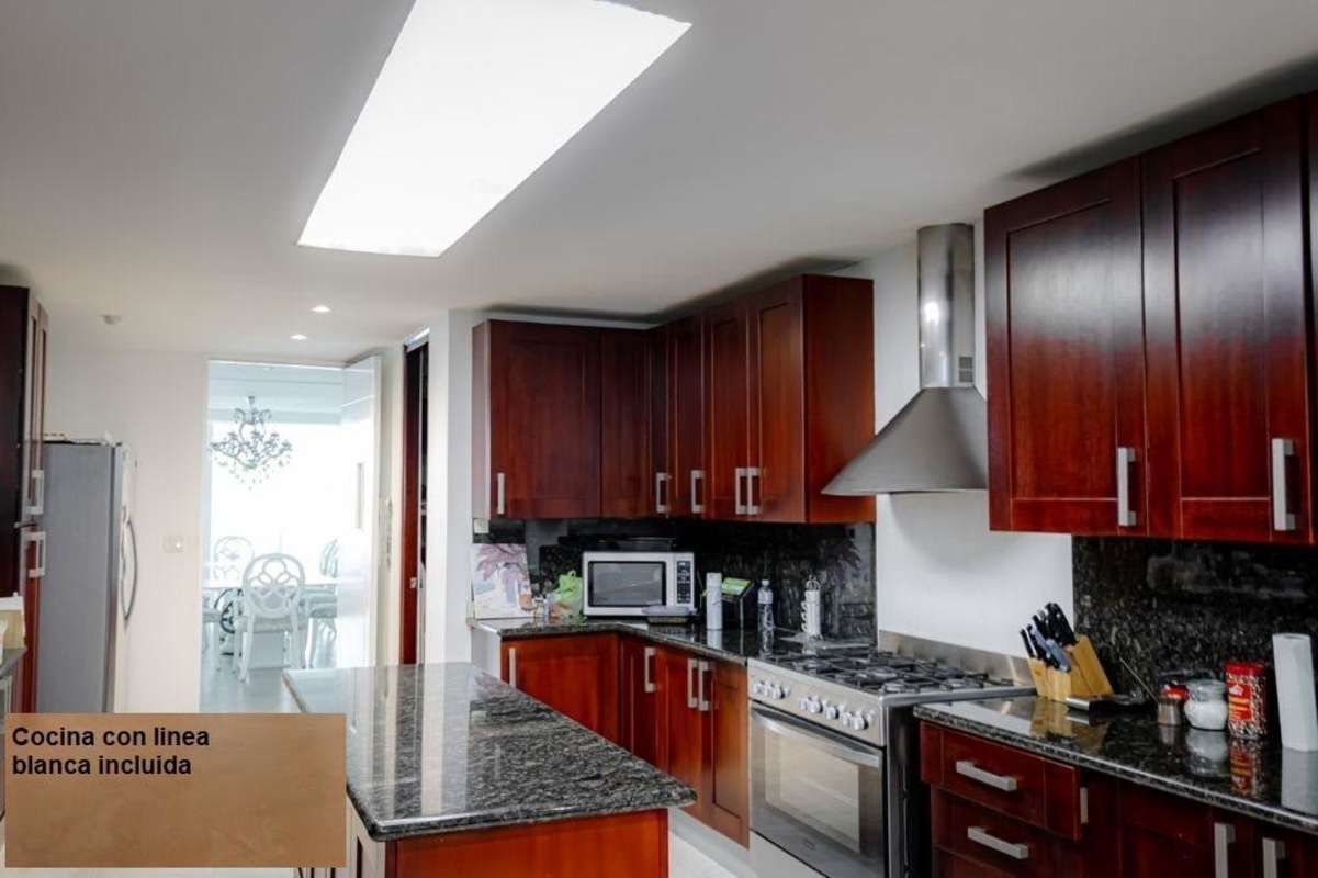 Gourmet kitchen with granite counters and stainless steel appliances in PH Aquamare Punta Pacifica