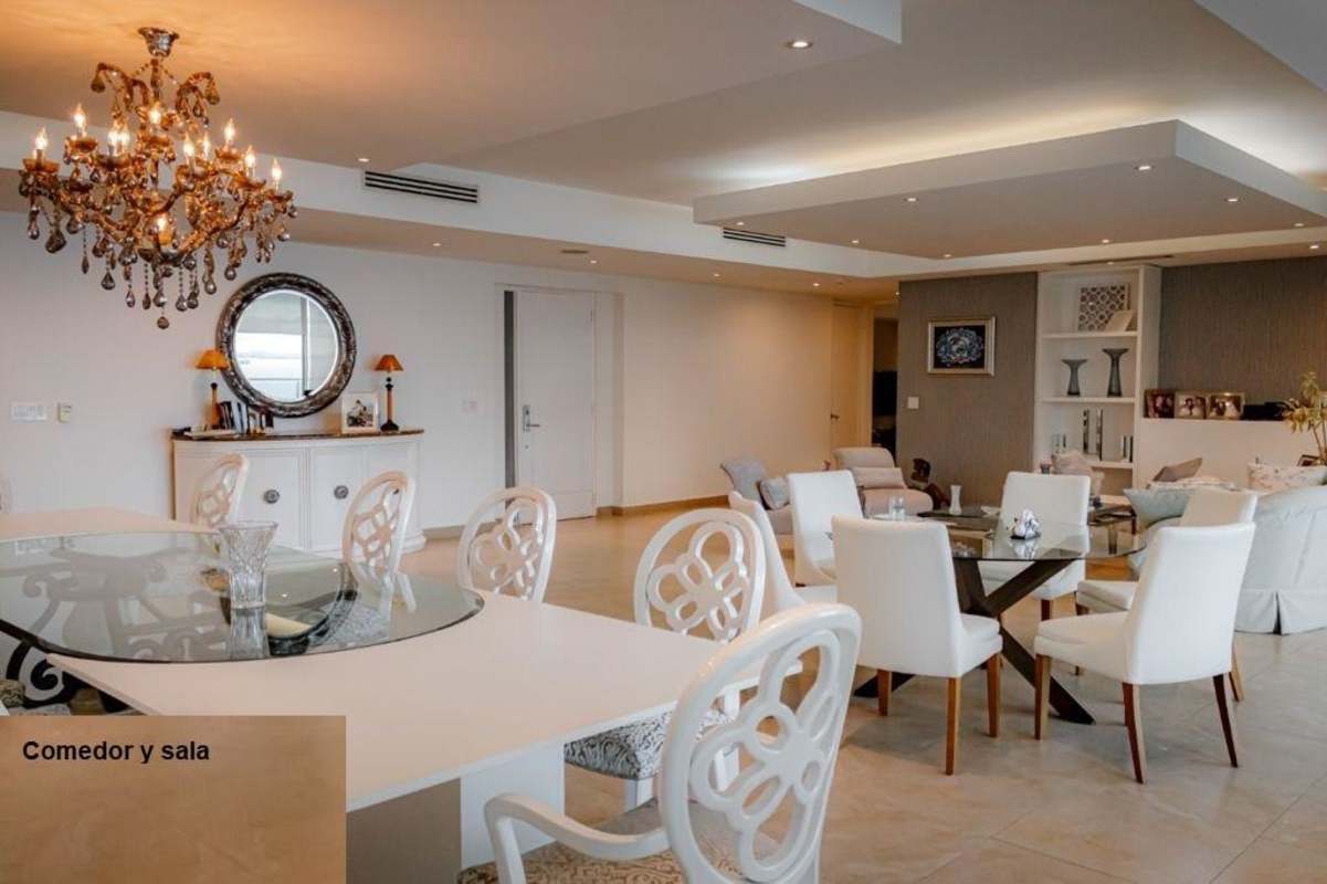 Open plan living and dining room with ocean view and chandelier Punta Pacifica Panama