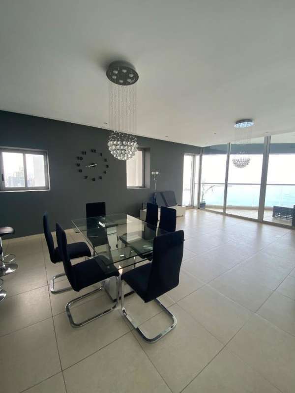 Modern kitchen with center island, gray cabinetry, and sea views PH Rivage Avenida Balboa