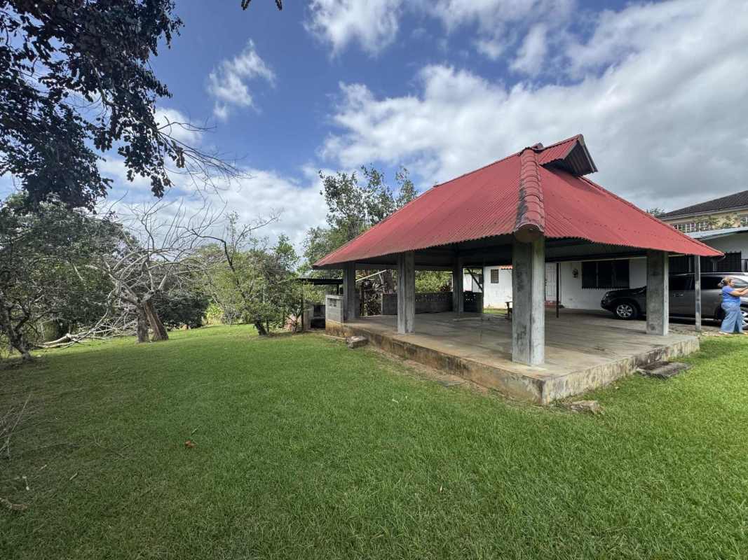 Gazebo with red roof beside farmhouse on rural land in Chepo Panama