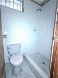 Second bathroom with shower toilet tiled wall Altos de las Huacas Vacamonte Panama house